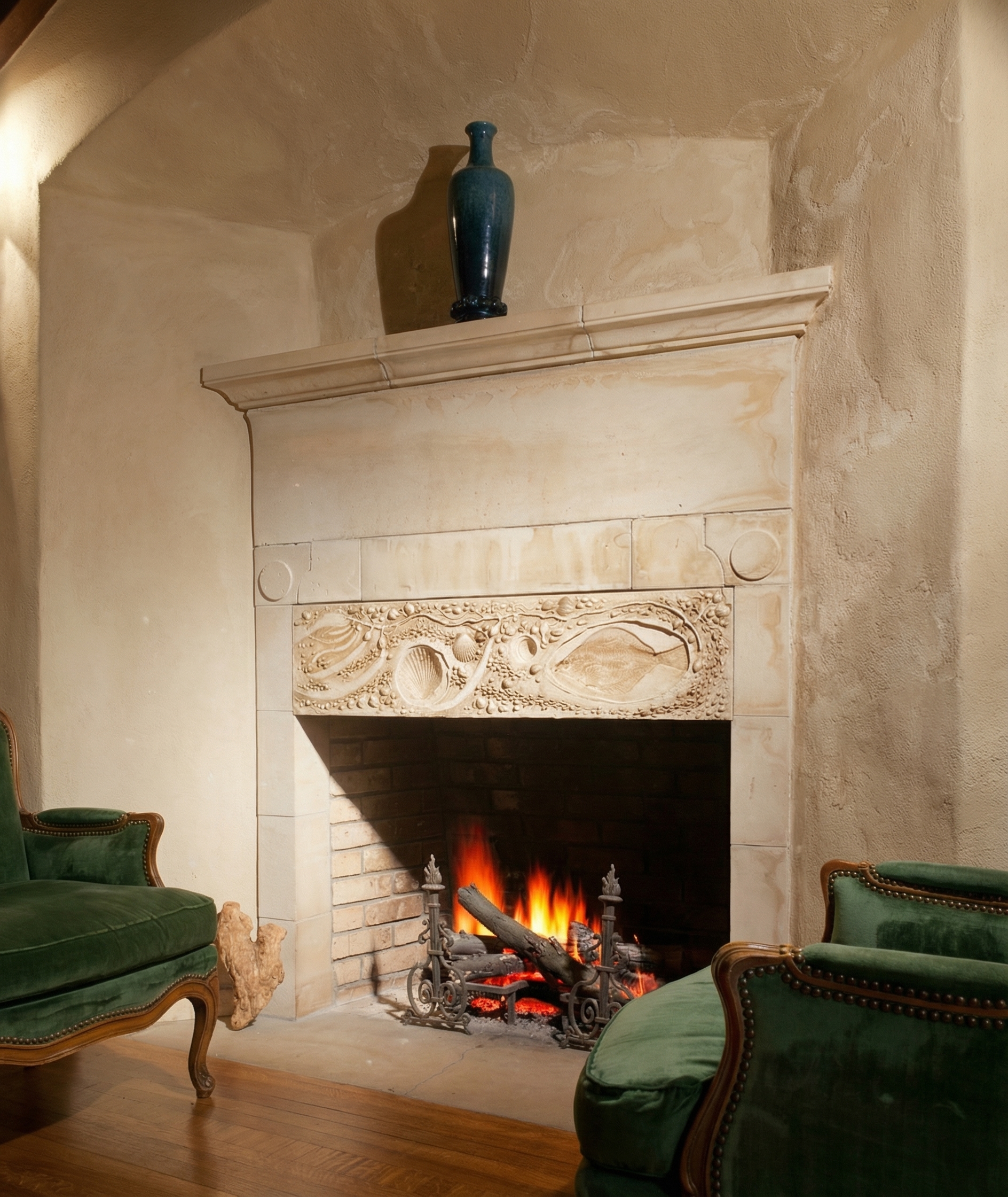 Interior detail of the granite fireplace at the D.L. James House showing the deep hearth, the stone chimney carried straight up through the wall, and the wood mantel set into the masonry with refined joinery